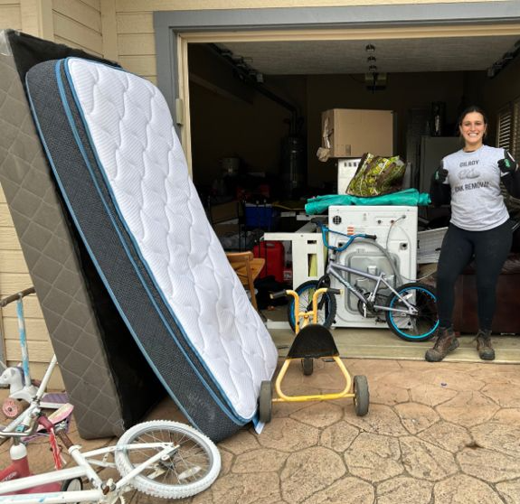 Gilroy garage packed with a mattress, bikes, and appliances before junk removal