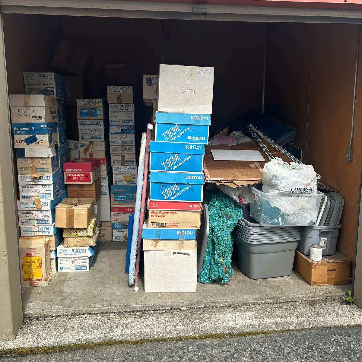Storage unit stacked full of boxes and totes before cleanout